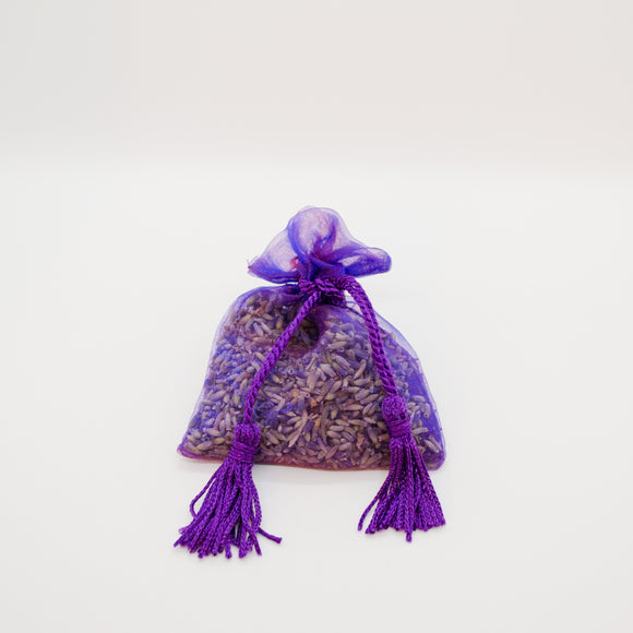 Dark purple organza bag with tassels filled with dried lavender buds