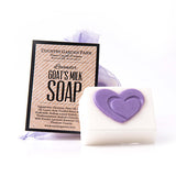 Small white bar of goat milk soap with purple heart packaged in lavender organza bag